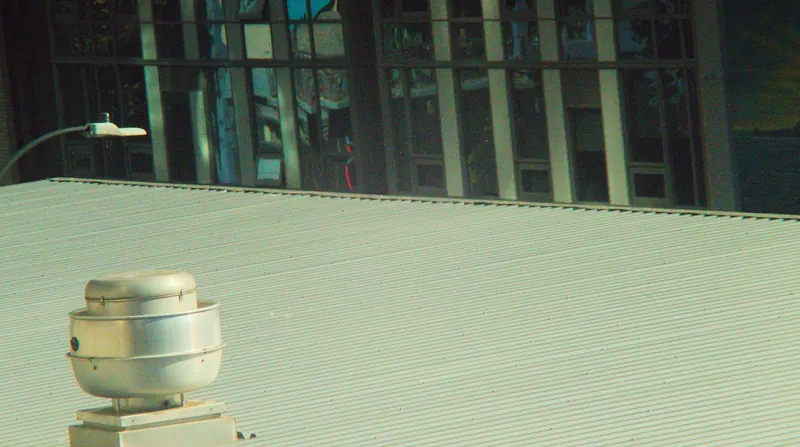 Rooftop exhaust vent on a commercial metal roof